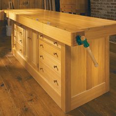 a large wooden workbench with drawers and handles