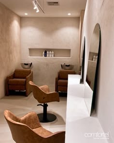 a hair salon with chairs and mirrors in the corner, one chair is up against the wall