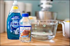 ingredients to make dishwasher detergent sitting on a kitchen counter next to a mixing bowl