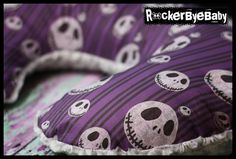 a purple pillow with skulls on it and the words halloween written in white across the image