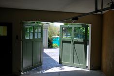 an open door leading into a house with green doors