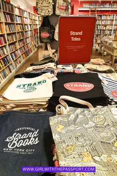 there are many books and t - shirts on display in the bookstore's store