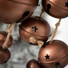 some metal bells with stars hanging from them