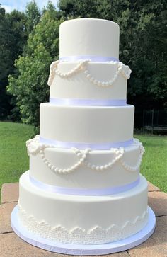 a large white wedding cake sitting on top of a table