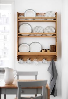 the front page of a magazine with an image of plates and dishes on shelves above a table