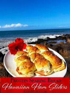 a white plate topped with bread next to the ocean