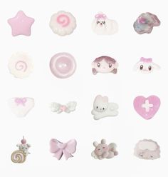 there are many different types of buttons on the white surface, including one with a pink bow