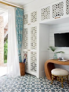 a room with white walls and blue patterned flooring