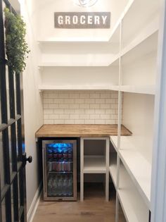 an empty pantry is shown with the door open and shelves full of water bottles in it