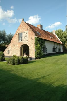 an old brick house with a red roof