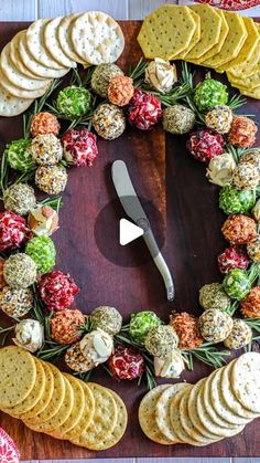 a platter with crackers and cheeses arranged in the shape of a wreath