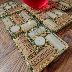 three coasters with different designs on them sitting on a wooden table next to a red ball