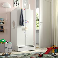 a white refrigerator freezer sitting inside of a child's room