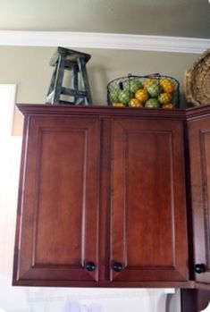 a wooden cabinet with some fruit on top