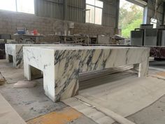 a large marble table sitting inside of a building