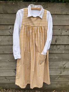 This dress is made from 100% pre-shrunk cotton. It has a bodice that closes at the back with three shell buttons. The skirt is full and the overall length from shoulder to hem is 48 inches (122cm). It is designed to be worn over a t-shirt or blouse or sweater. It has two patch pockets, in matching fabric. Will it fit? Check all the measurements on my website -- https://www.rosablue.com/custompinafore Womens Pinafore Dress, Witchy Fashion, Shell Buttons, Pinafore Dress, Overall Dress, Fit Check, Yellow Dress, My Website, Gingham