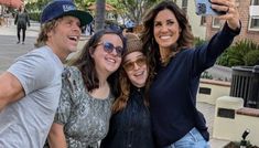 three people taking a selfie with their cell phone