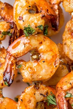 grilled shrimp with herbs and spices on a white plate