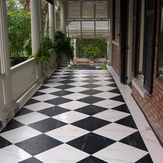 a black and white checkered floor in front of a building