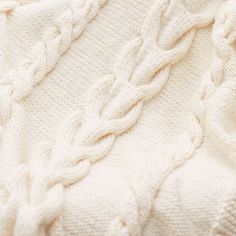 an image of a white sweater with cables on it