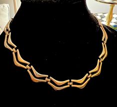 "Vintage Monet Scalloped Statement Necklace, 70s Mid Century Modern Shiny Goldtone Chic Disco Era Choker Collar Necklace, Sleek Minimalist designer jewelry  It measures approximately 18\" long . It is signed with a Monet hang tag, and an adjustable hook clasp.  A wonderful signed  addition or beginning to any vintage jewelry collection.  A terrific quality  necklace & a stunning gift idea ❤️ purchased single owner estate sale  It is in very good vintage condition, with only minor  signs of any w Chic Disco, 70s Mid Century Modern, Disco Era, Choker Collar Necklace, Monet Jewelry, Vintage Monet, Choker Collar, Hang Tags, Collar Necklace