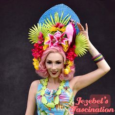 Breezy Days - Huge tiki headdress with a central cool blue straw fan adorned with bright greenery and tropical pink and yellow flowers and a pink parrot perched among the vivid flora. Perfect for your tiki pin up look while at your next tiki event! Fan Headpiece, Pin Up Looks, Parrot Perch, Dapper Day, Palm Fronds, Costume Hats, Flower Headband, Headdress, Blue Bird