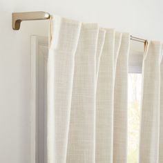 an open window with white curtains and a curtain rod