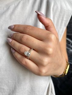 a woman's hand with a ring on it and a diamond in the middle