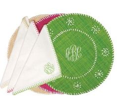 three monogrammed placemats on top of each other