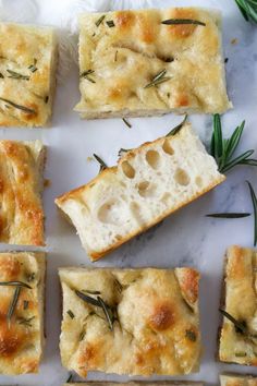 several slices of bread with rosemary sprigs on top