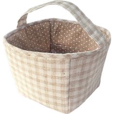 a brown and white checkered fabric basket with polka dots on the inside, sitting against a white background