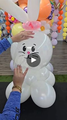 a person touching an inflatable bunny balloon