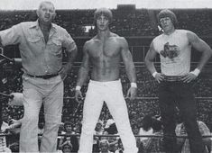 three men standing next to each other on a tennis court