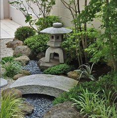 a small garden with rocks and plants around it