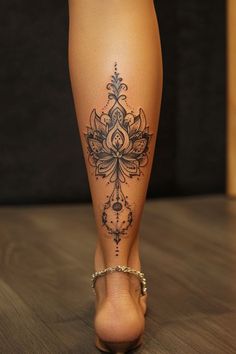 a woman's leg with a tattoo on it and her foot in high heels