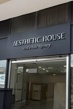 the front entrance to aesthetic house real estate agency, which is located in an industrial building