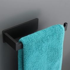 a black towel rack with a turquoise towel hanging on it