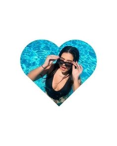 a woman wearing sunglasses standing in front of a pool with a heart shaped frame over her eyes