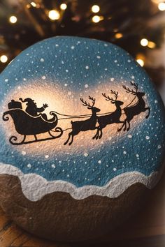 a painted rock with santa's sleigh on it