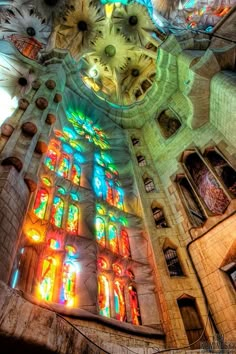 the inside of a church with stained glass windows and colorful lights on it's ceiling