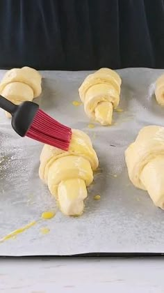 dough being spread on top of a baking sheet