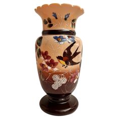 a decorative vase with birds and flowers painted on it