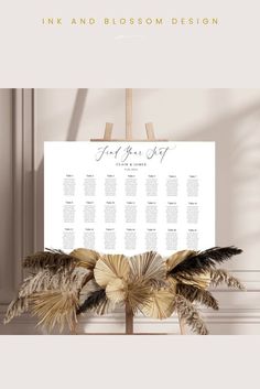 a wedding seating chart with feathers on it