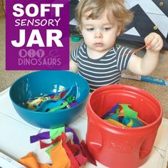 There are so many soft things you can put in this Soft Sensory Jar for your toddler! Think pom poms, feathers, fabric scraps, ribbon, string, yarn, and pipe cleaners. We loved throwing these items in the air and making them fall to the ground, sorting them into buckets, and comparing shapes, colors, and sizes! diyanddinosaurs.com Edible Paint, Sensory Boards, Enjoy Nature, Pipe Cleaner, Cotton Candy Machine, Play Time, Fabric Scraps