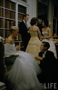 a man in a tuxedo sitting next to a woman in a white dress