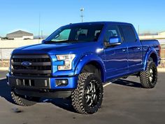 a blue truck parked in a parking lot