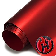 a close up of a red metal object on a white background with the letter h