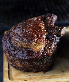 two meats on a cutting board next to an open bbq grilling pan