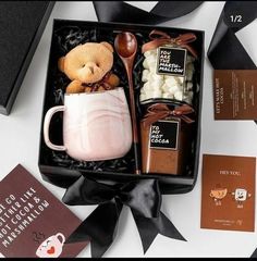 a gift box with coffee, marshmallows and a teddy bear