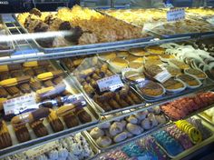 a display case filled with lots of different types of pastries